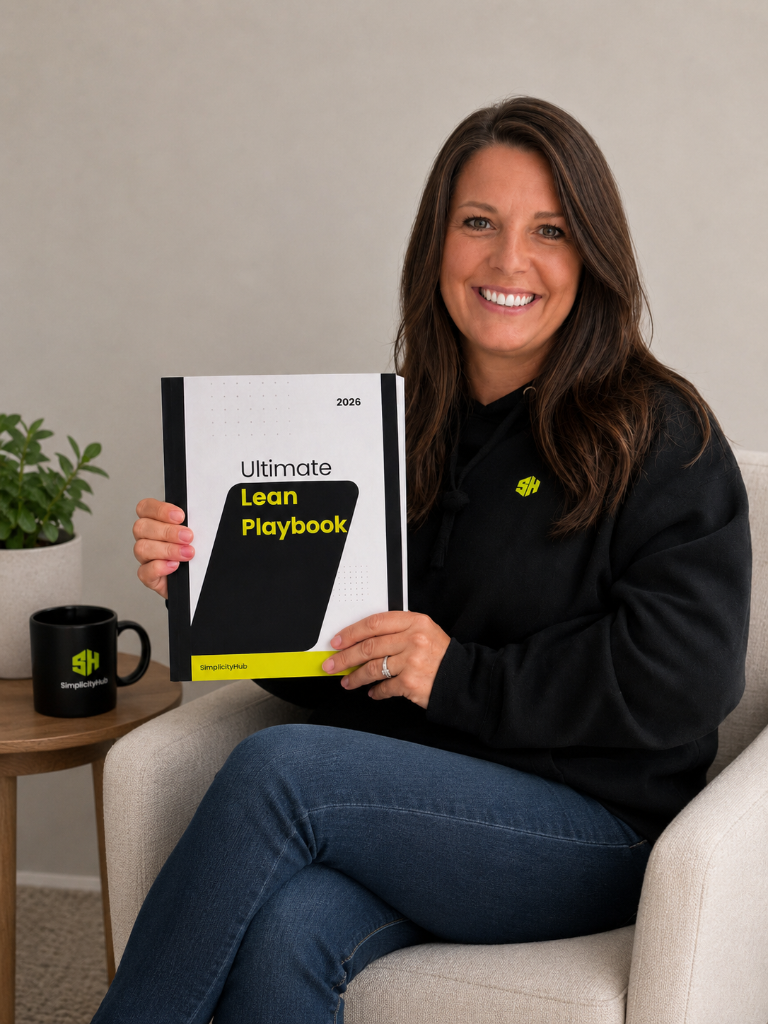 SimplicityHub founder holding The Ultimate Lean Playbook